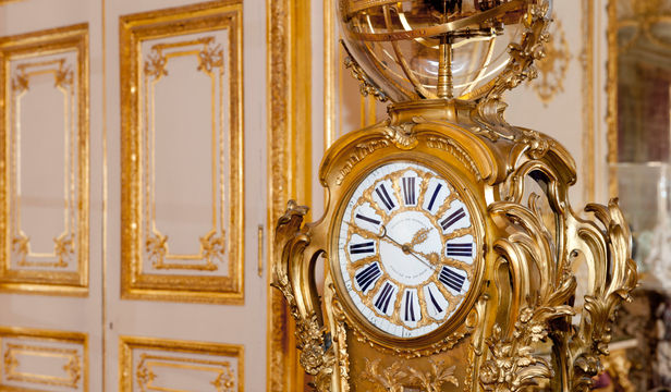 Opulent golden watch: Timeless elegance captured within Versailles Palace's walls, a magnificent display of grandeur.