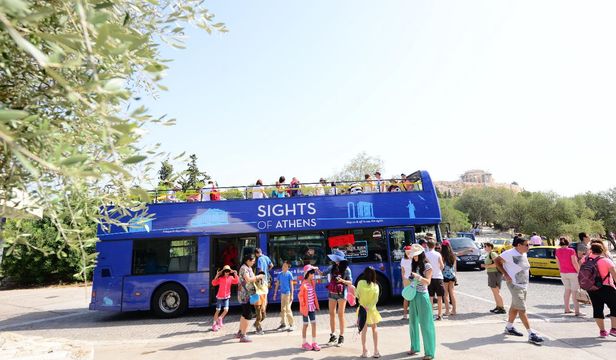 Passengers eagerly boarding the Athens Hop-on Hop-off Bus, ready to embark on a thrilling journey of exploration and discovery.