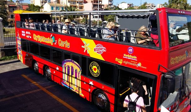 City Sightseeing Corfu: Hop-On, Hop-Off Bus ready for exploration - passengers hopping on, eager to begin their Corfu adventure.