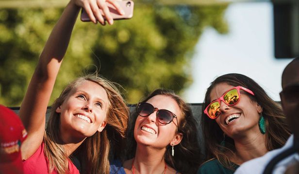 Friends capturing a memorable moment on City Sightseeing Thessaloniki Hop-On, Hop-Off bus with a fun-filled selfie adventure.