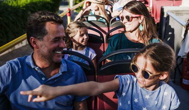 A father and daughter share joyous memories aboard the City Sightseeing Thessaloniki Hop-On, Hop-Off bus, creating cherished memories.