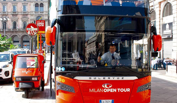 Vibrant red Milan Open Tour Hop-On, Hop-Off bus, offering a convenient and enjoyable way to explore the city's attractions.