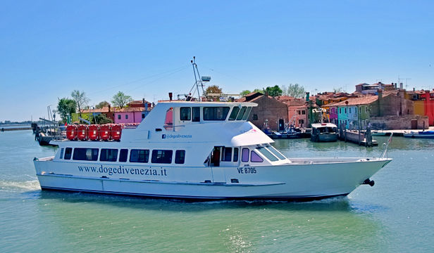A cruise ship gracefully gliding through the waters surrounding Murano and Burano Islands, showcasing their picturesque beauty.