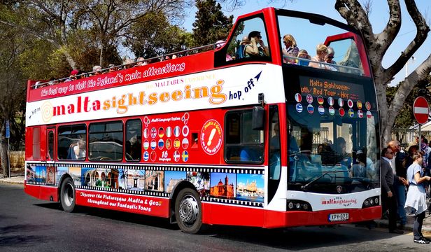 Passengers disembarking the vibrant red Malta Sightseeing bus, eager to explore the wonders of Malta's diverse attractions.
