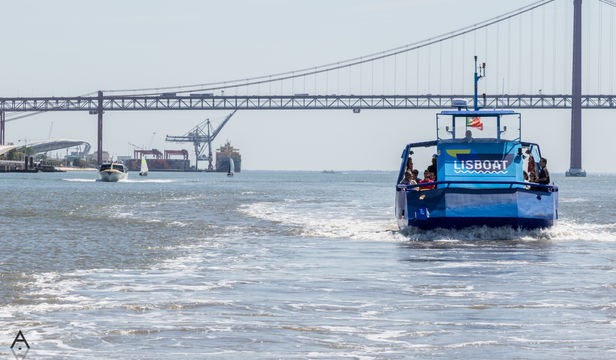 Hop-On Hop-Off boat cruising along Lisbon's river, creating a splash of excitement while exploring the city's waterfront delights.