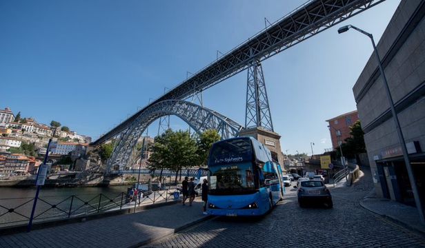 Gray Line Porto Hop-On Hop-Off Bus traversing the streets of Porto, offering a convenient and flexible way to explore the city's highlights.