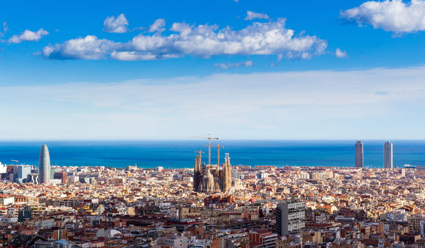 Breathtaking aerial view: Barcelona's beauty, mesmerizing cityscape, and vibrant urban panorama with houses and sea.