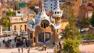 Mesmerizing aerial view of Park Guell with visitors exploring the park, immersed in its beauty and charm, a captivating scene in Barcelona.