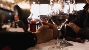 Tourists enjoy fine dining and wine at Ai Coristi Restaurant, immersed in a gastronomic journey amidst a charming ambiance.