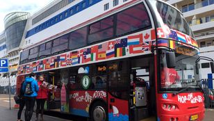 Eager passengers ready to embark on the adventure of a lifetime, hopping on the iconic Red Sightseeing Copenhagen Hop-On, Hop-Off Bus.