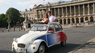 Romantic Montmartre ride: Smiling couple embraces adventure in an iconic 2CV, creating cherished memories in Paris.