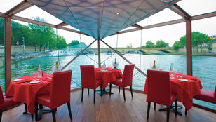 Indulge in an exquisite dining experience aboard the Seine River cruise, surrounded by beautiful river-facing views.