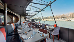 Captivating dining experience on a Seine River cruise ship, immersed in stunning scenic river views, a feast for the eyes and taste buds.