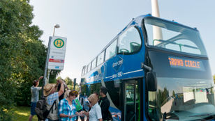 Excited passengers eager to board the GrayLine Munich Hop-on, Hop-off Bus, ready to begin their memorable exploration of the city.