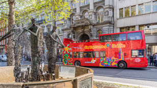 City Sightseeing Dublin: Hop-On, Hop-Off bus gracefully gliding through the vibrant streets of Dublin, showcasing the city's charm.