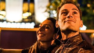 A beautiful couple savoring the enchanting Big Bus Dublin Panoramic Night Tour, embracing the romance of the city's illuminated charm.