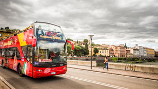 Spectacular views of Florence city unfold as passengers revel in the sights from the moving bus, capturing the essence of its beauty.