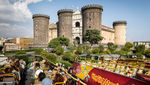 Captivating moments captured from a bright red city sightseeing bus in Naples, Italy, as passengers photograph the breathtaking scenery.