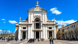 A stunning photo of Papal Basilica of Saint Mary, a beautiful church nestled in the serene landscape of Assisi, Italy.