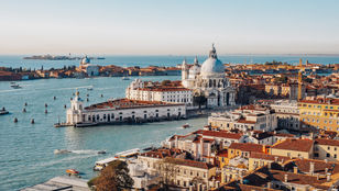 A top-view image captures the scenic beauty of Venice city, showcasing its distinctive architecture and enchanting canals from above.