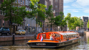 Happy tourists on canal cruise ride: Immersed in enjoyment, savoring the serene atmosphere and delightful cruise experience.
