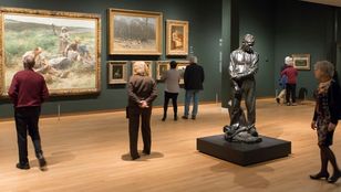Tourists captivated by Van Gogh's art inside the renowned Van Gogh Museum, immersed in the beauty of the museum's collection.