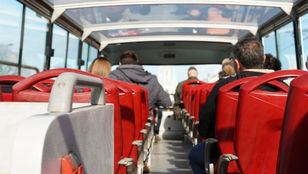 Passengers immersed in joy aboard the Hop-On, Hop-Off Bus Sightseeing Ålesund, savoring the city's treasures with delight.