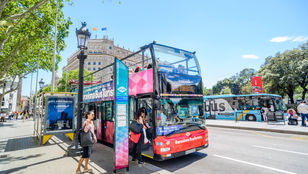 Vibrant Barcelona Turistic Hop-On, Hop-Off bus traversing the city streets, providing an immersive and flexible sightseeing experience.