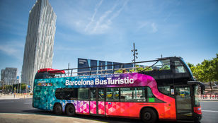 Colorful Barcelona Turistic Hop-On Hop-Off bus ready to explore: A vibrant city adventure awaits passengers in this captivating ride.