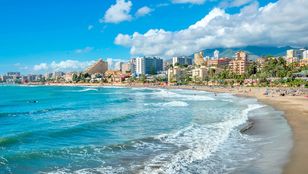 Captivating beach of Benalmadena with a stunning cityscape as the backdrop, inviting you to soak in its natural beauty.