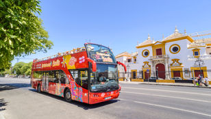 Vibrant Seville comes alive on our open-top bus! Hop on, hop off and soak up the city's charm with our excited passengers on board.