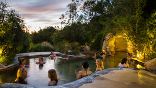 Travelers unwind at Peninsula Hot Springs, enjoying serene relaxation and embracing the tranquil ambiance of this blissful destination.