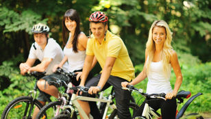 Sydney Cycle Tourists pause, pose with bikes against iconic backdrops, preserving joyful moments in picturesque snapshots.
